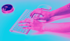 a person's hands typing on a keyboard