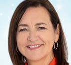 a woman in a red shirt and earrings