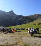 a group of people standing at Stella Alpina around a mountain