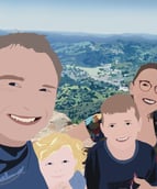 a family of three people standing on a mountain