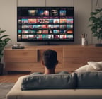 A smartphone displaying a streaming app interface, showing various movie and TV show thumbnails. The screen includes categories like 'For you' and 'New release hit films', with images from popular films. The background is a dimly lit setting with a fabric surface.