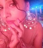 a woman with a large earring and a large earring
