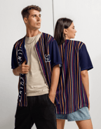 a man and woman standing next to each other wearing YESHUA Apparel jerseys