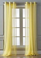 Pair of sheer yellow curtains hanging from a grommet rod over a window.