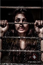 beautiful young girl captive behind bars, with eyes wide open in hope.