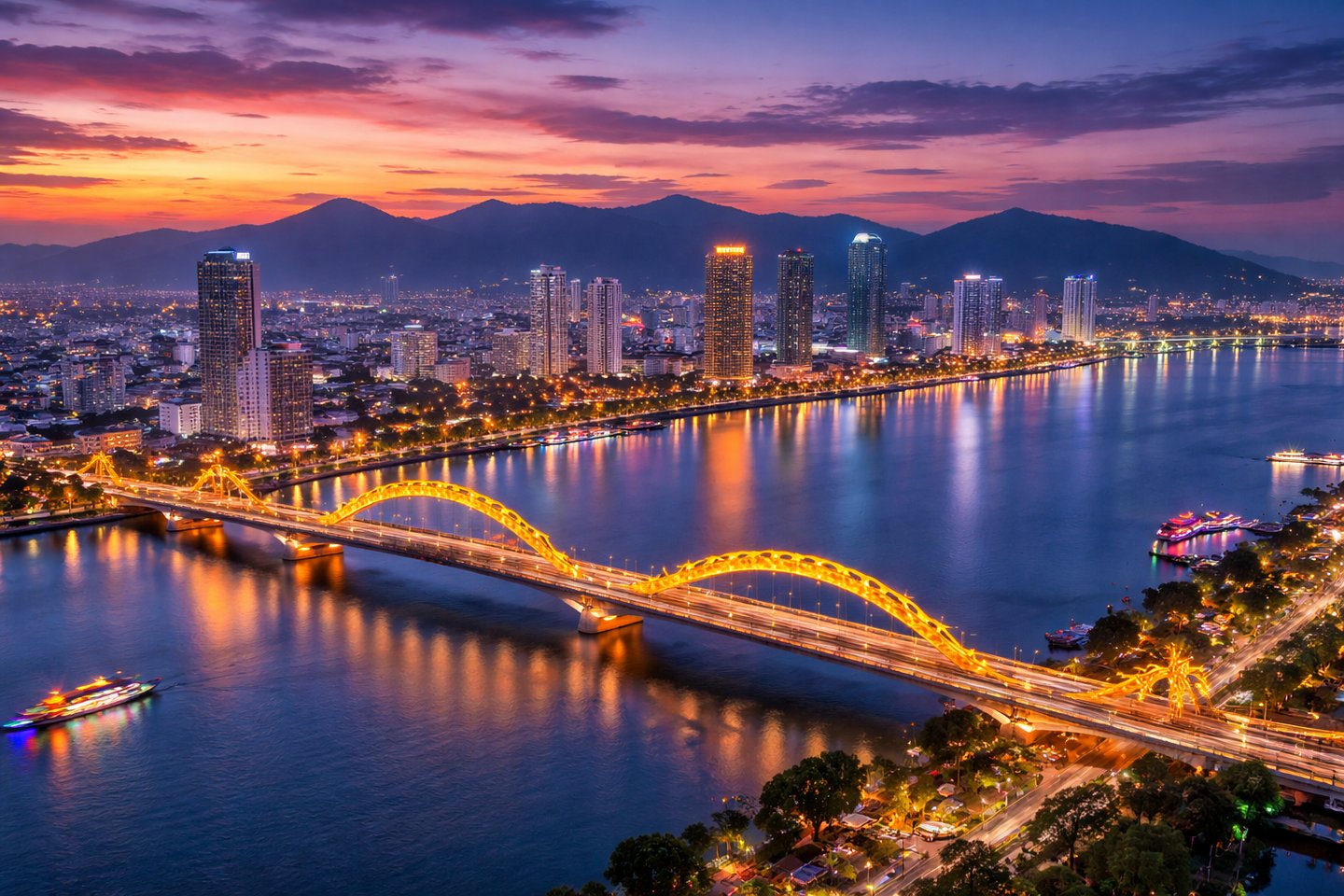 This image shows a stunning twilight view of Da Nang with the glowing Dragon Bridge stretching acros