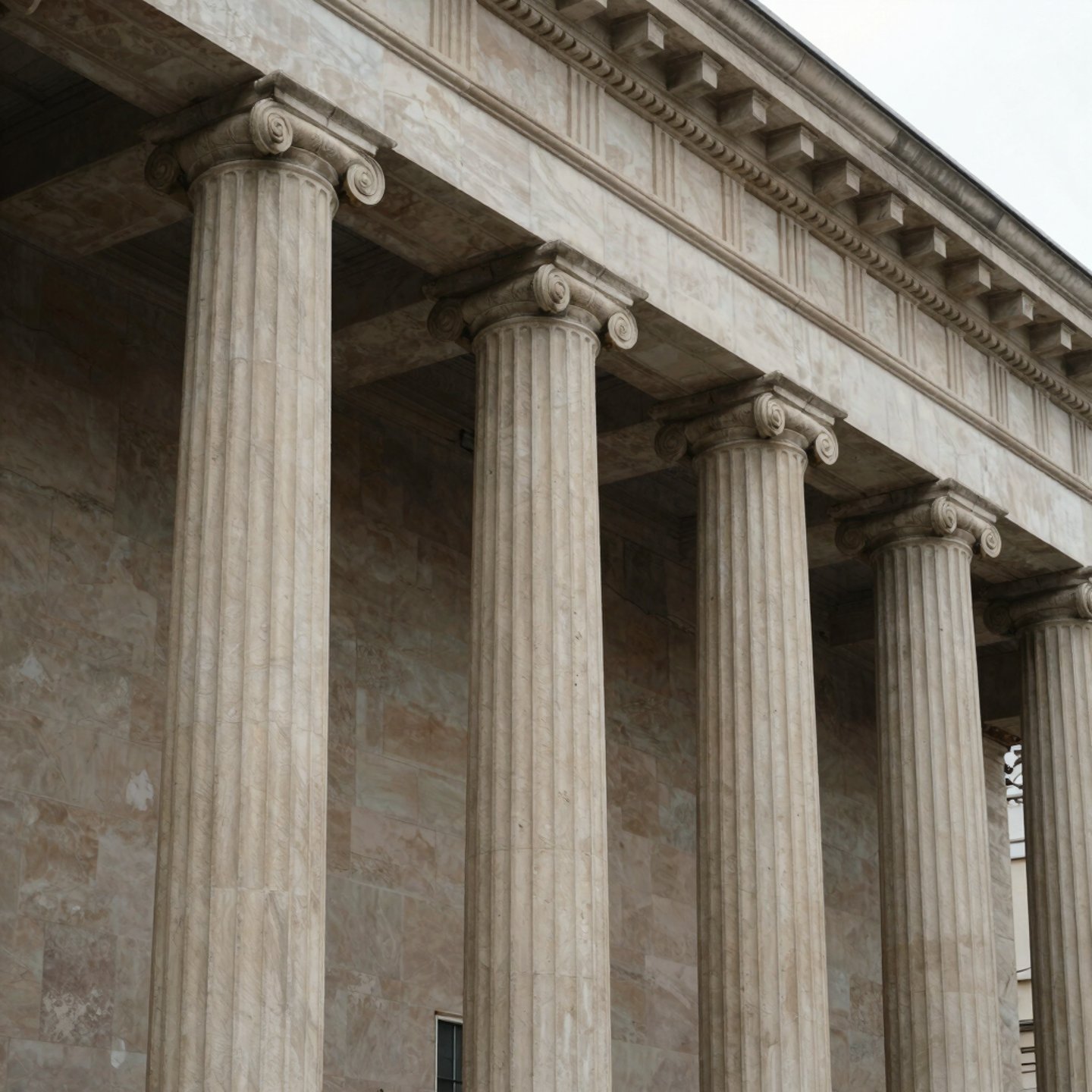 Classical marble building featuring fluted ionic columns and traditional greek architecture.