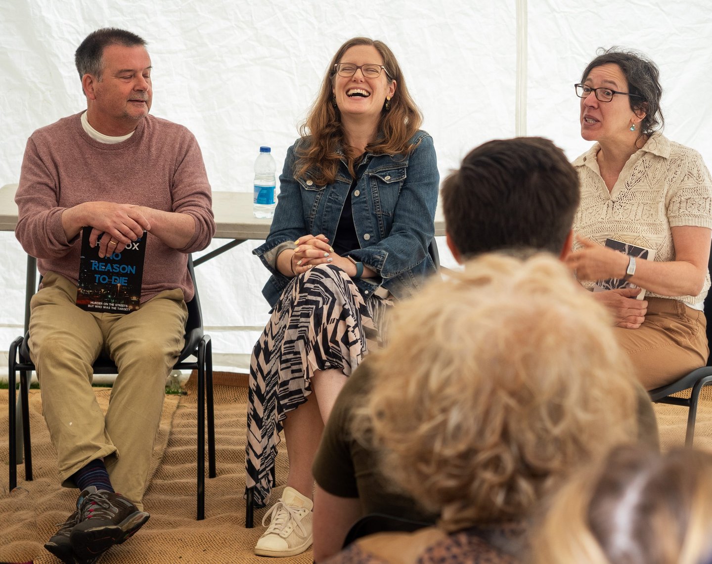 Three authors laugh on a panel at Herts Book Festival.