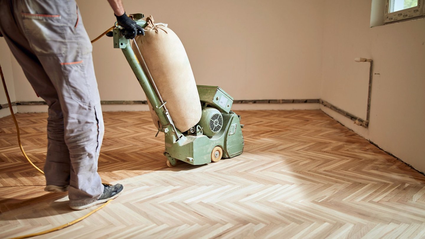 Professional flooring sanding wood floors with a belt sander. Serving Everett, Mill Creek, Mukilteo
