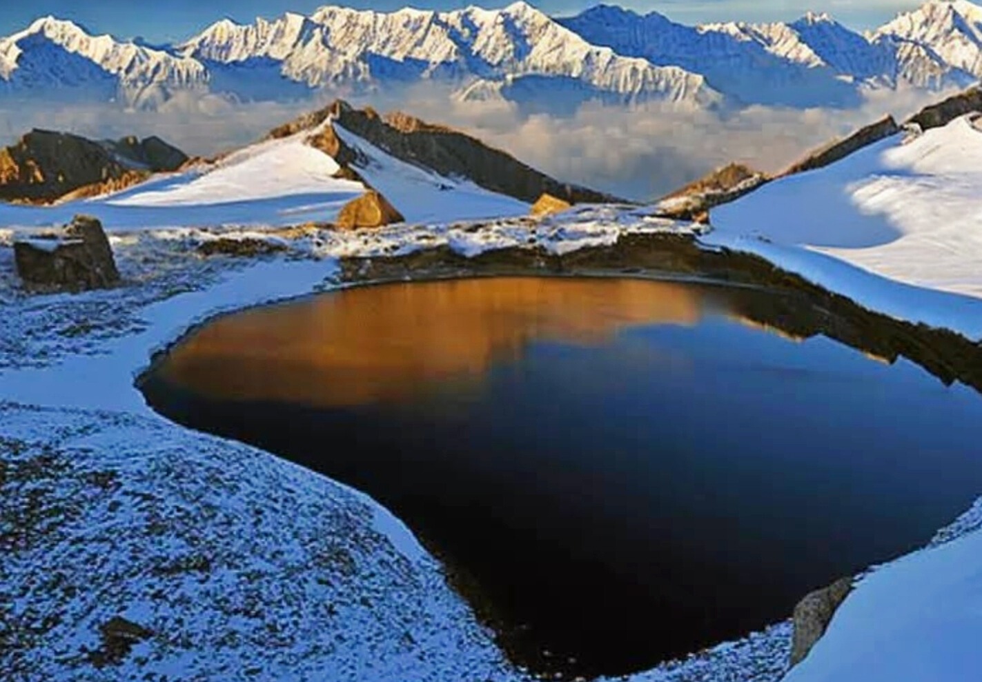 Ansoo lake surrounded by snow covered mountains
