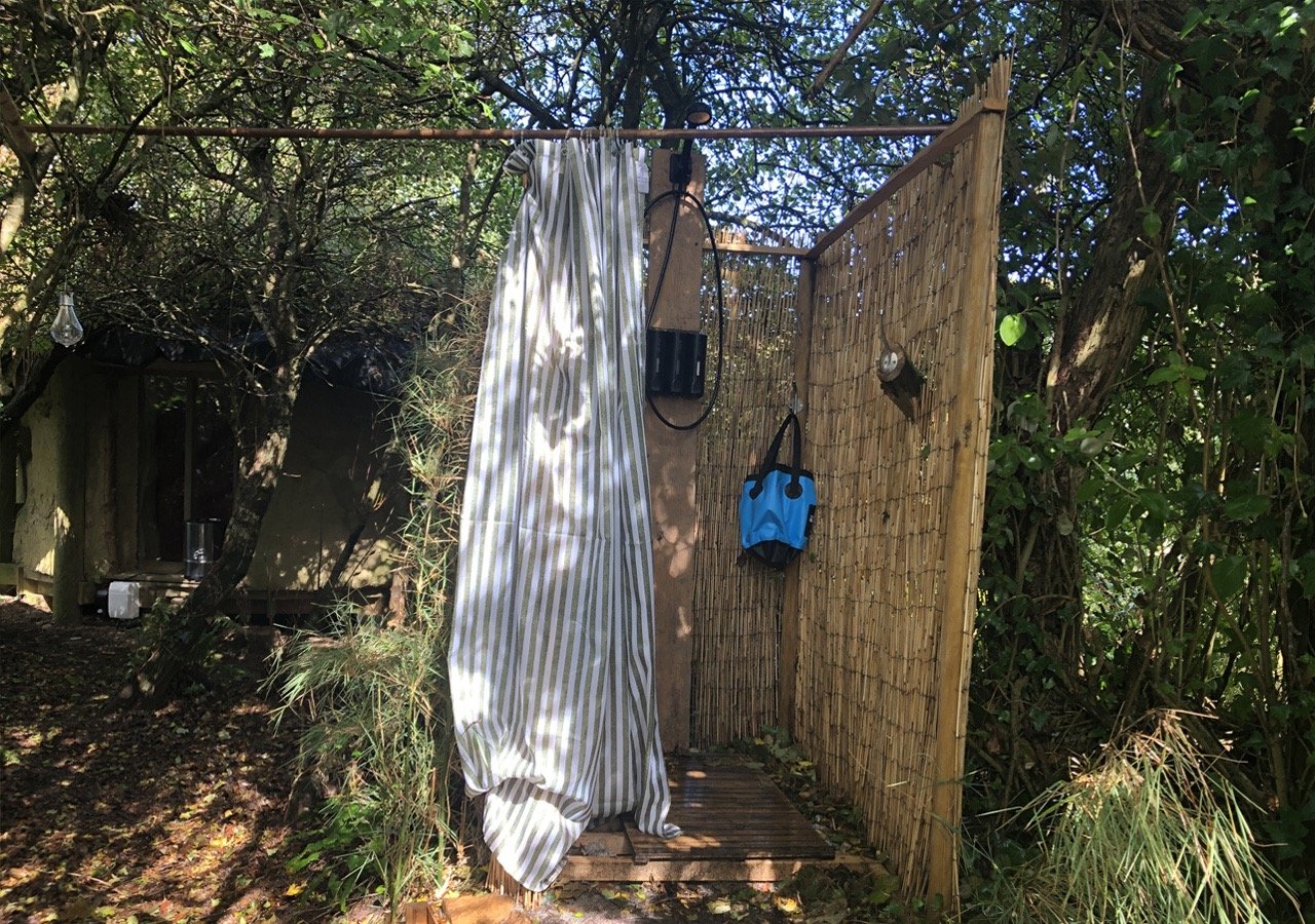 bamboo constructed outdoor shower set in woodland