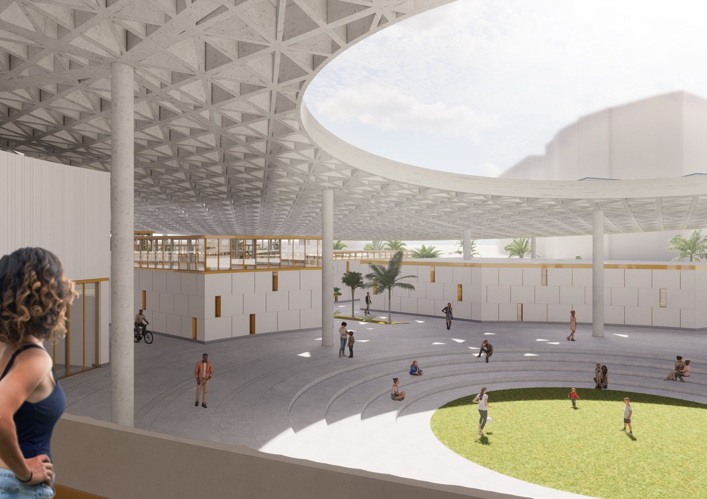 A woman looking out from a balcony at a large plaza underneath a triangulated concrete roof