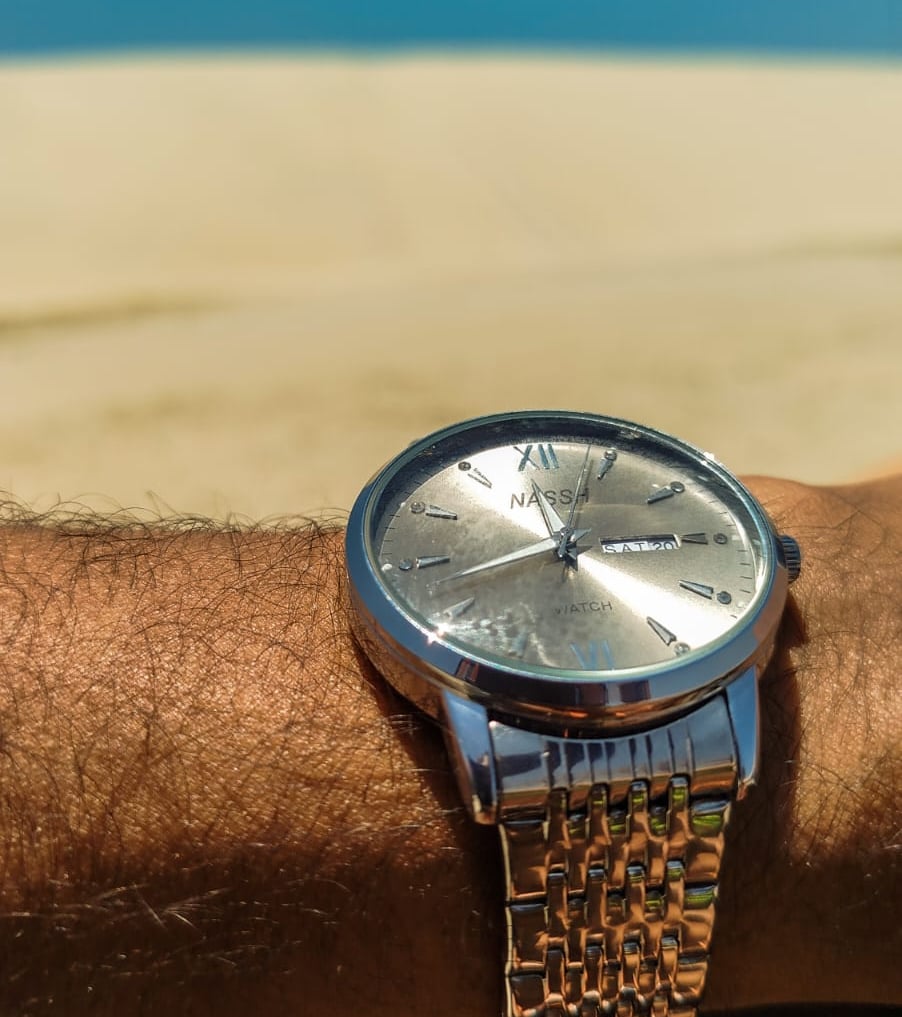a man's wrist watch on a wrist