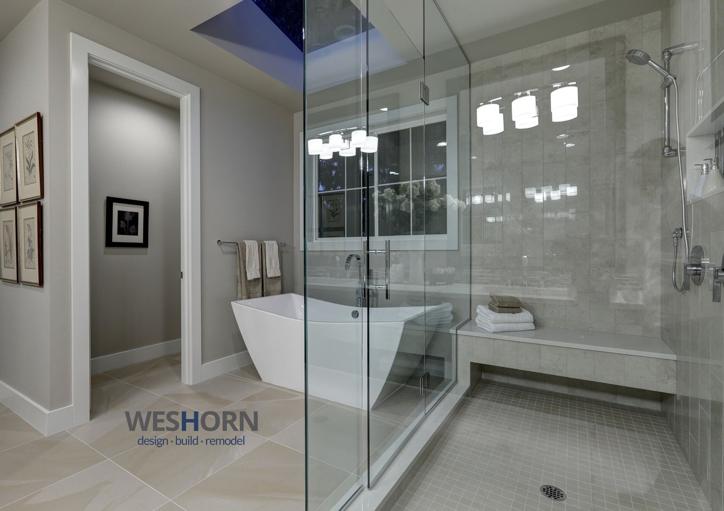 Modern luxury master bathroom remodel featuring a freestanding soaking tub and glass walk-in shower.
