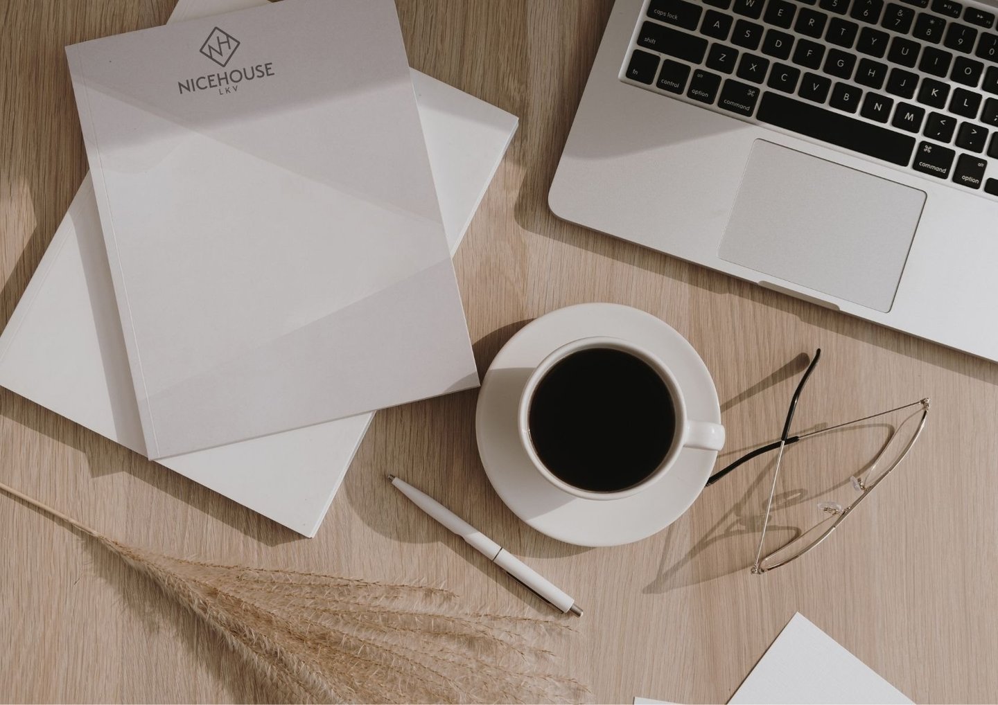 a laptop computer and a cup of coffee on a table