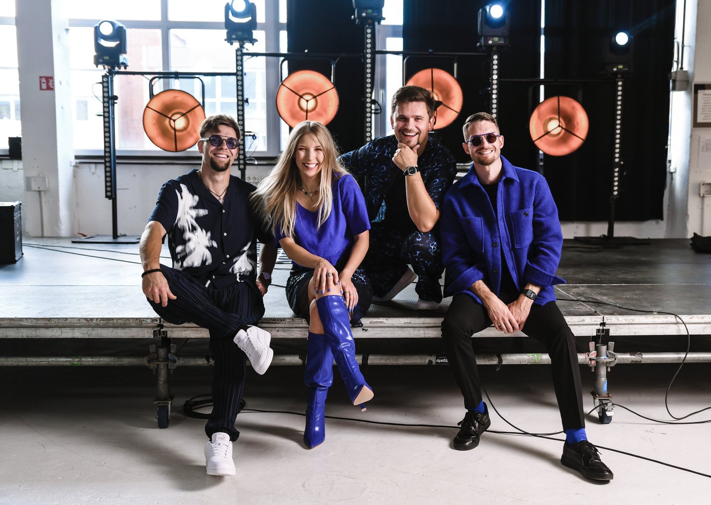 a group of people sitting on a stage