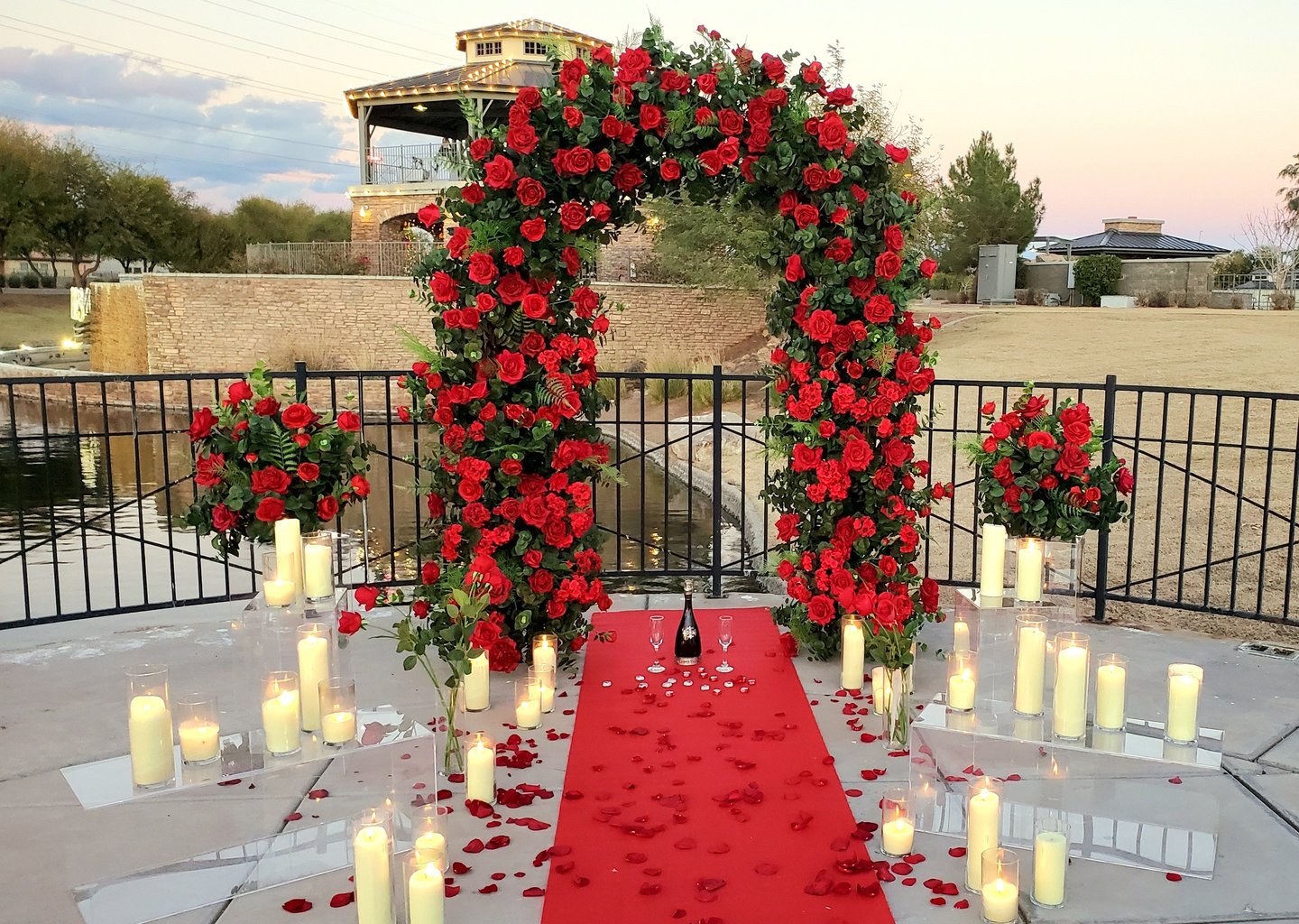 romantic red rose wedding ceremony arch red carpet surprise proposal with candles and rose petals