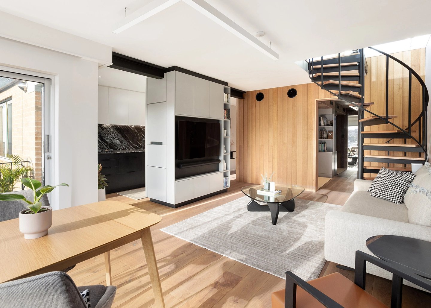 contemporary design of the renovated living room in Mosman Bay with central TV joinery cabinet and timber features
