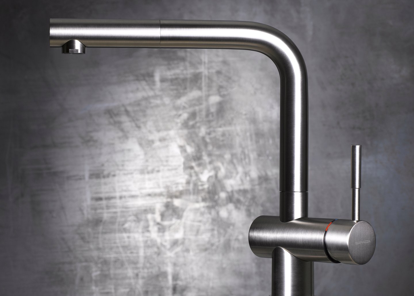 brushed chrome kitchen mixer tap against metal background