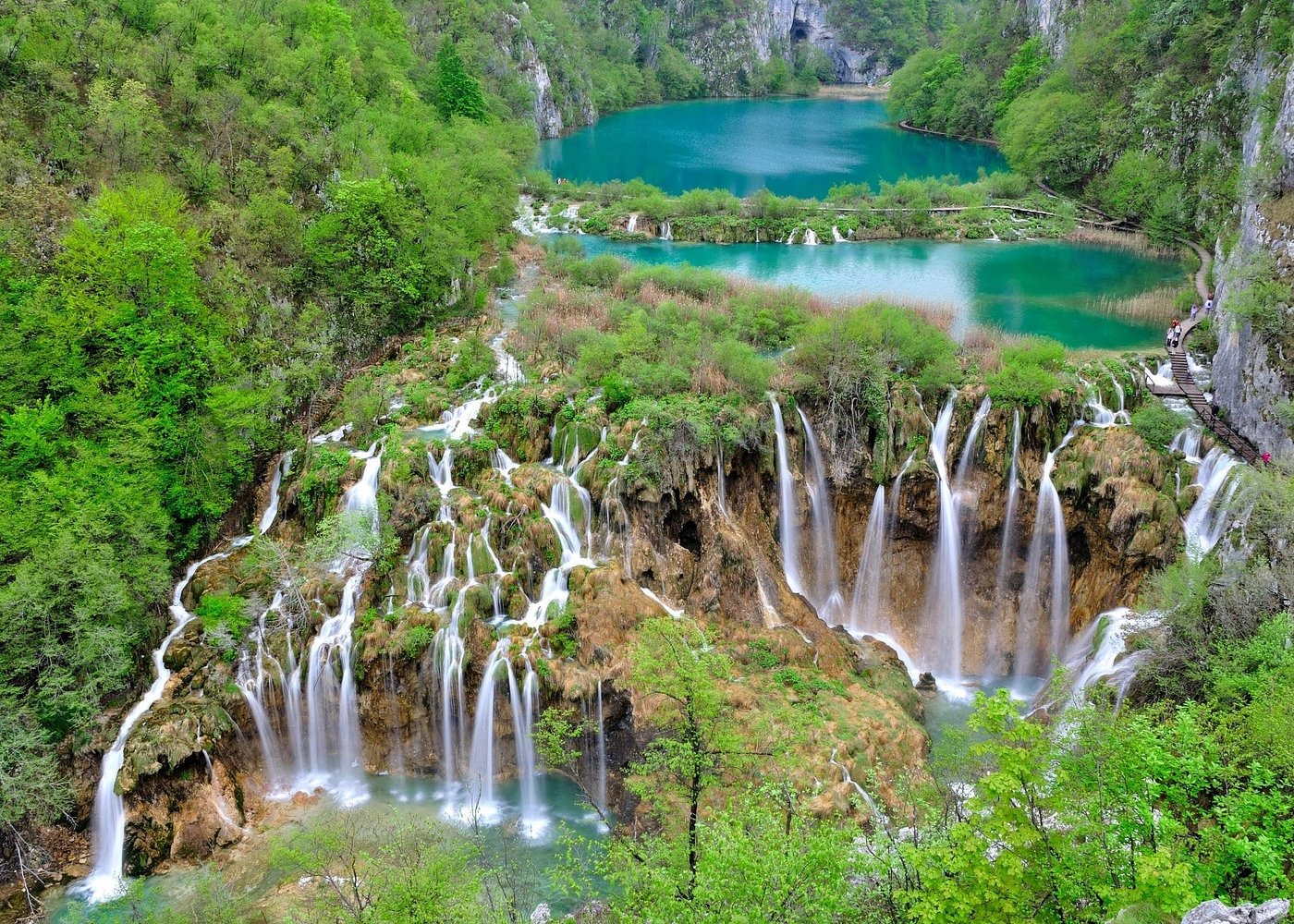 Aerial view of cascading waterfalls and turquoise lakes at Plitvice Lakes National Park in Croatia.