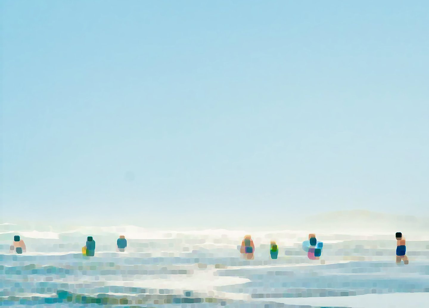 a group of people standing on a beach
