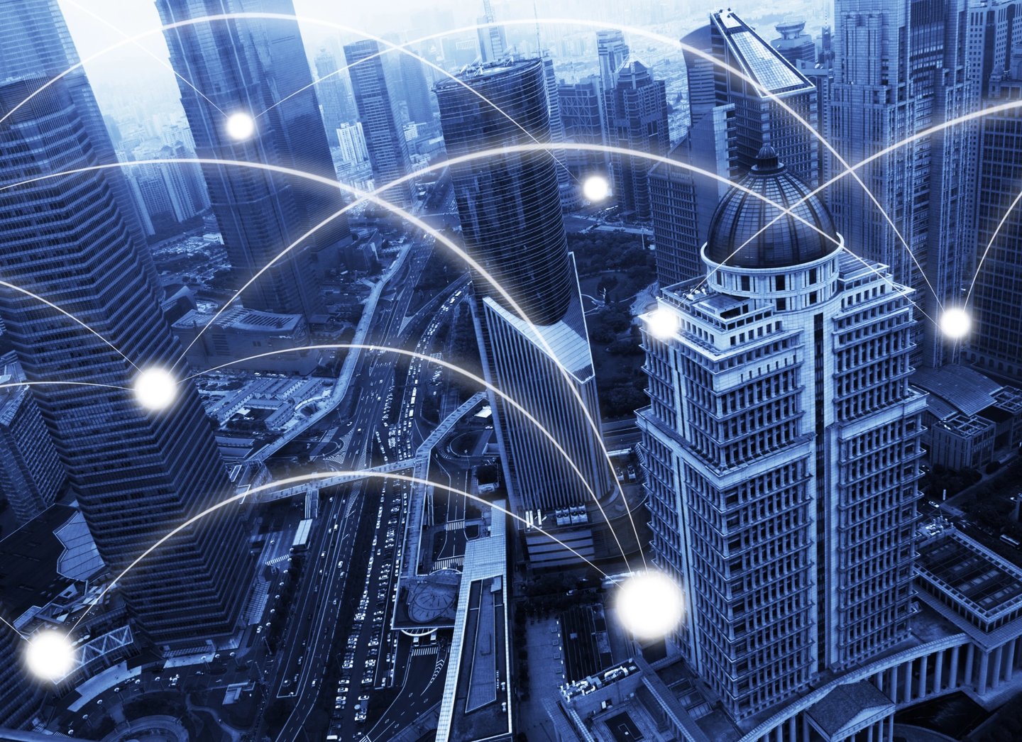 Smart city concept featuring global network connections over a modern urban skyline with blue digital overlays.