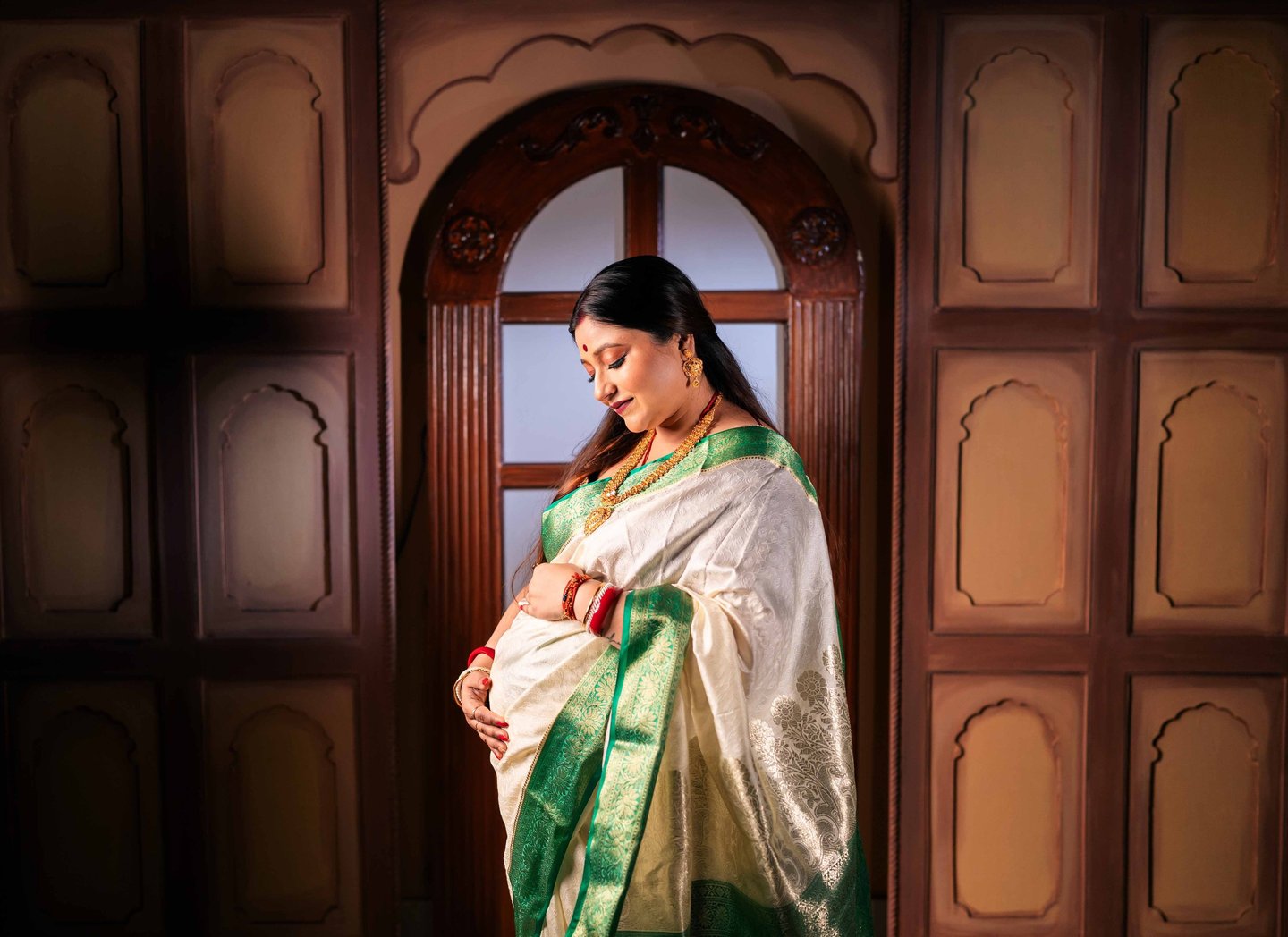 Mother-to-be posing during an indoor maternity photography session