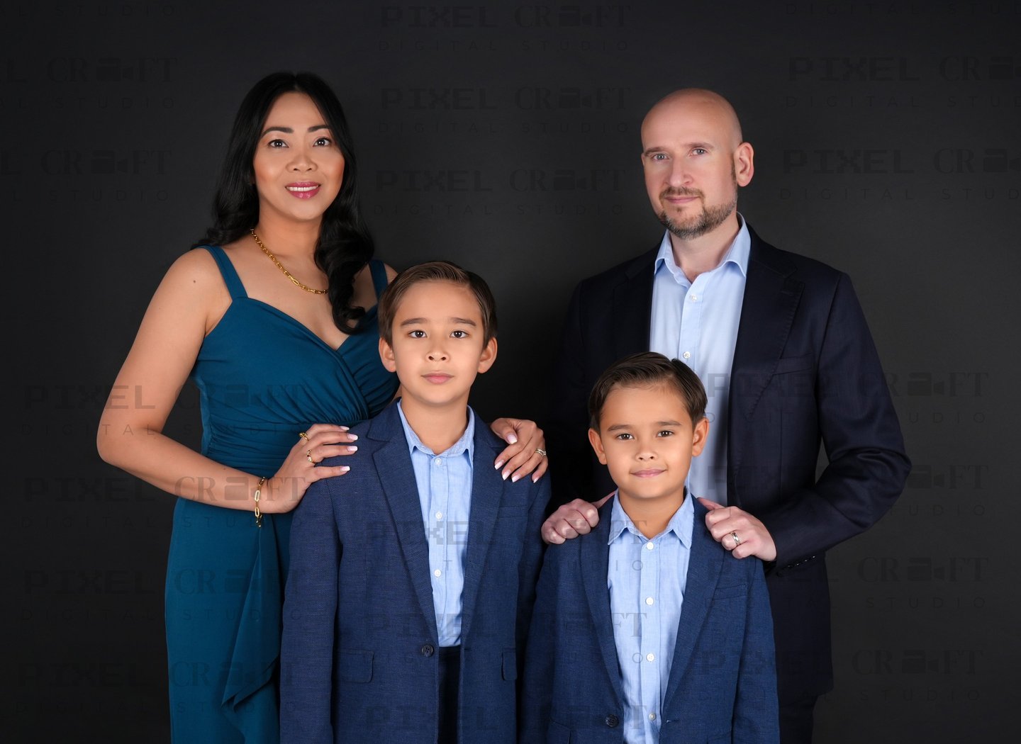 Smiling parents and kids sharing a loving moment in a beautifully lit family portrait.