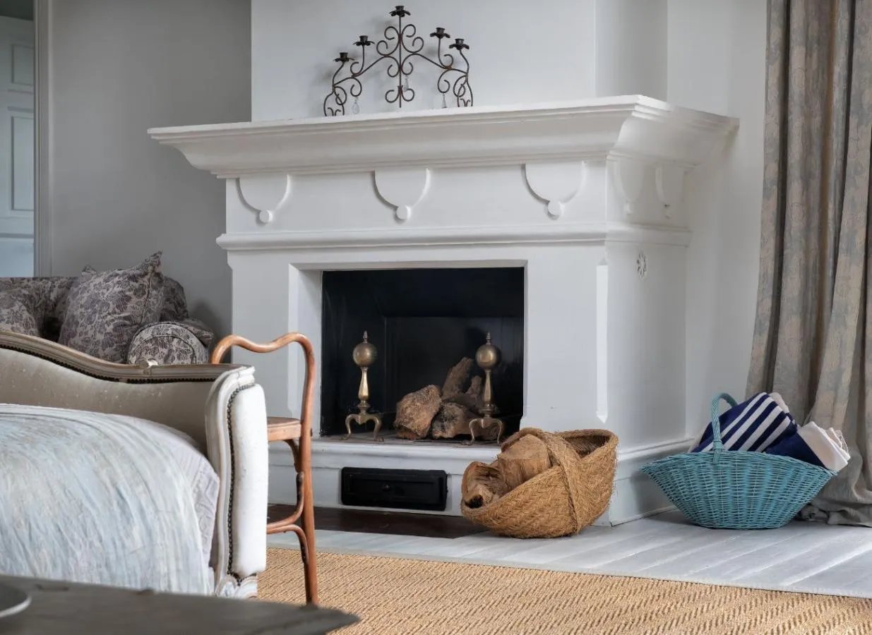 Fireplace with baskets and decor at Finca Santa Katerina