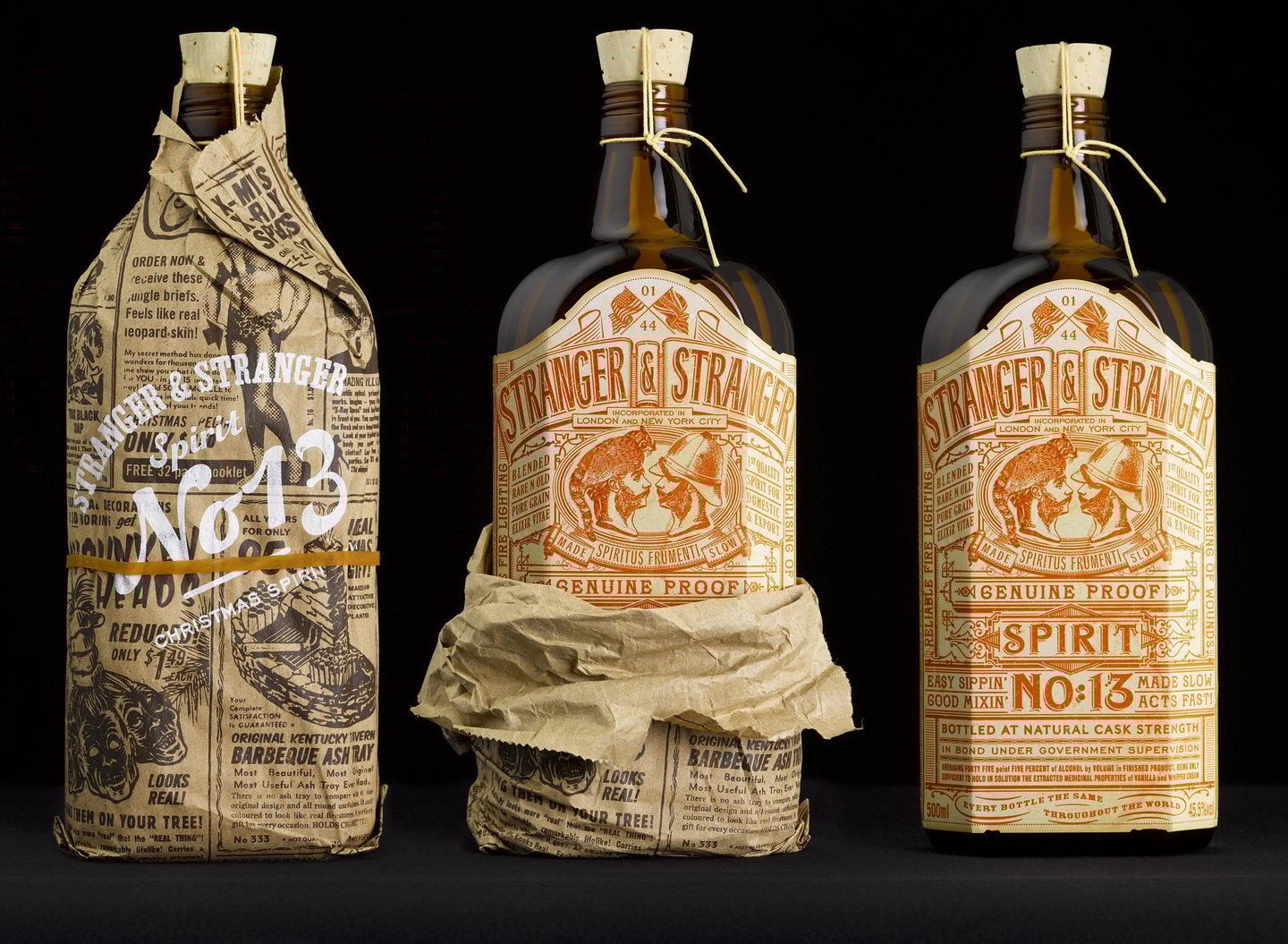 Three bottles wrapped in brown paper on a black background