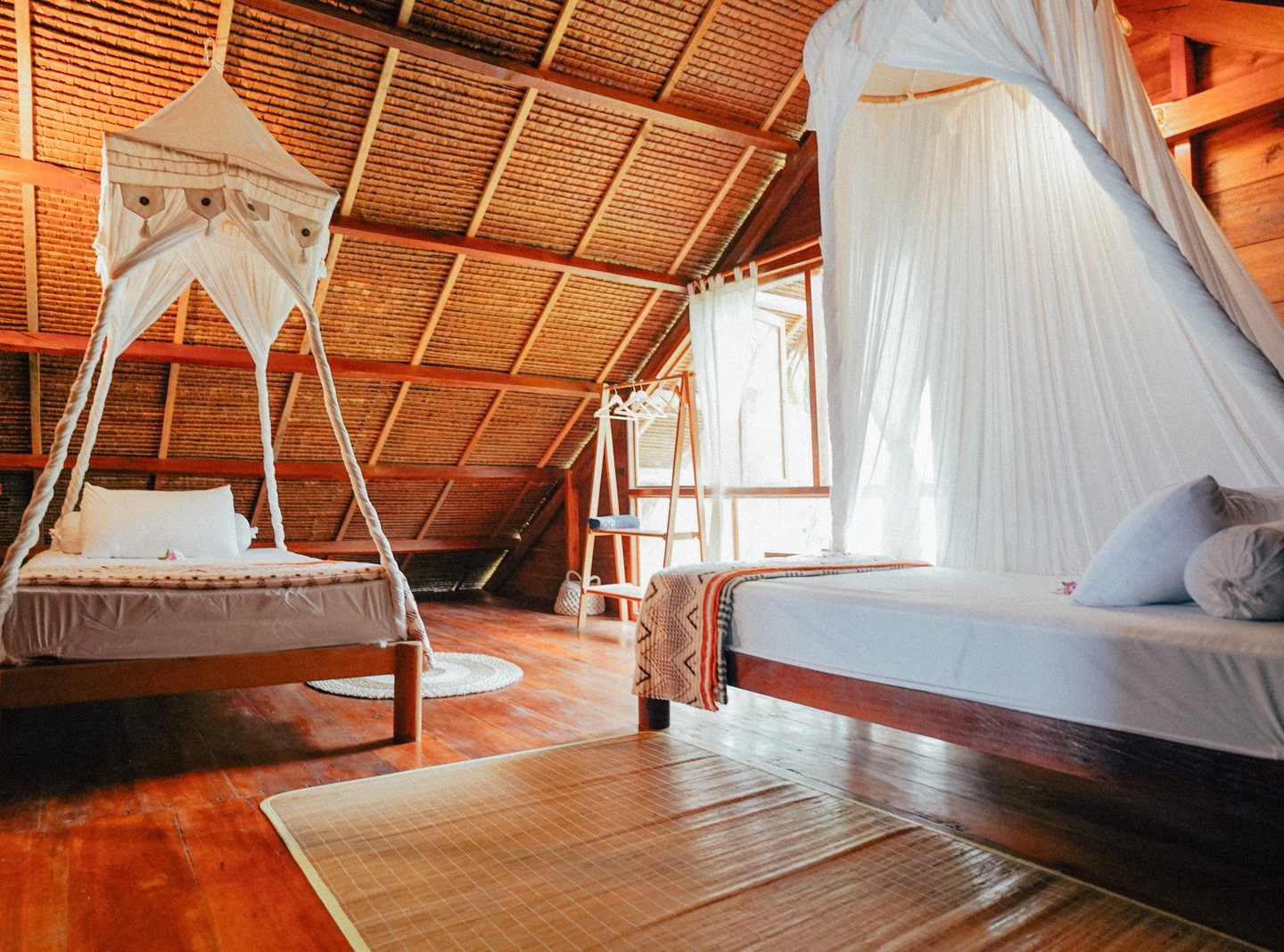Cozy double bedroom in Toska Surf House with canopy bed and wooden interiors