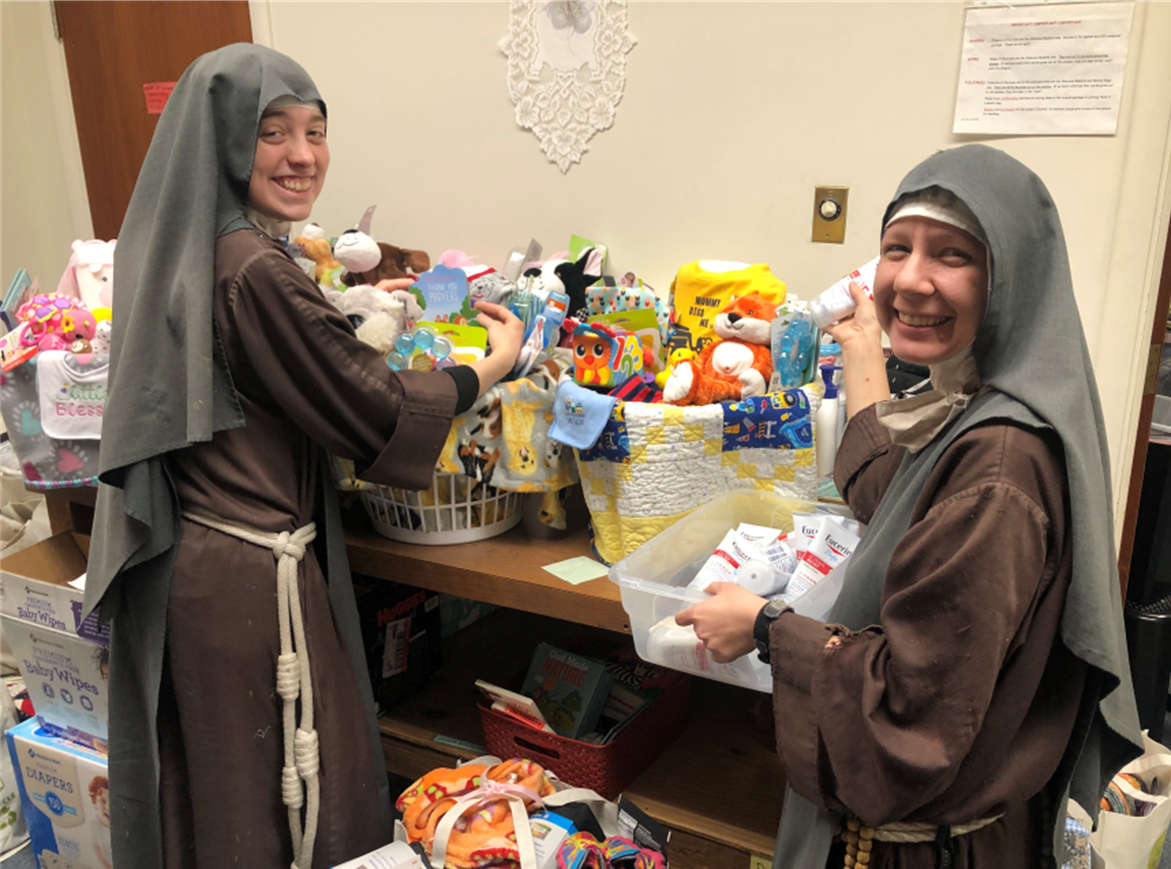 Sisters assembling new baby welcome baskets