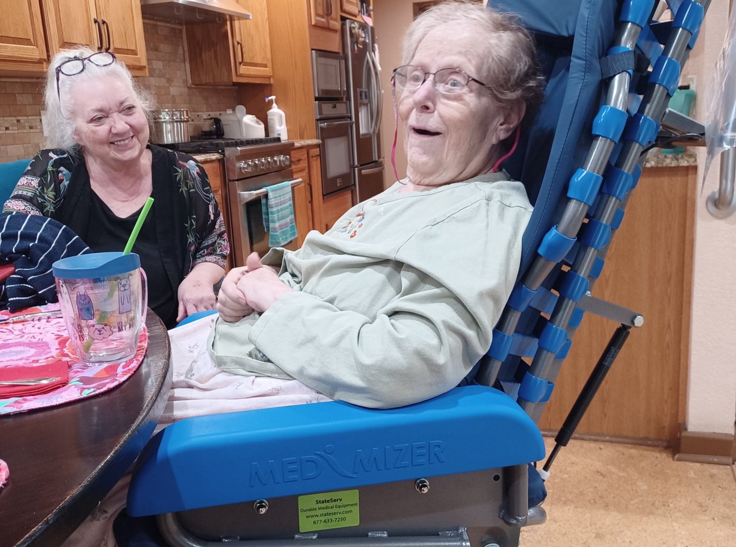 happy smiling older woman with happy caregiver daughter