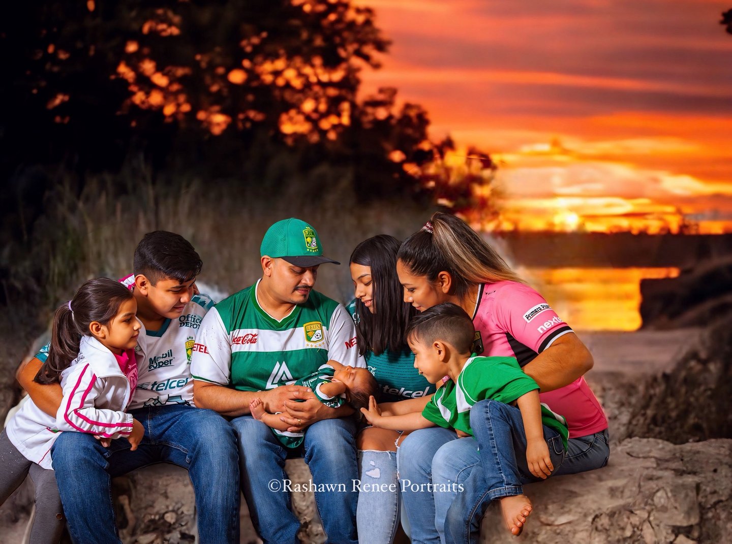 a family of five sitting on a rock wall