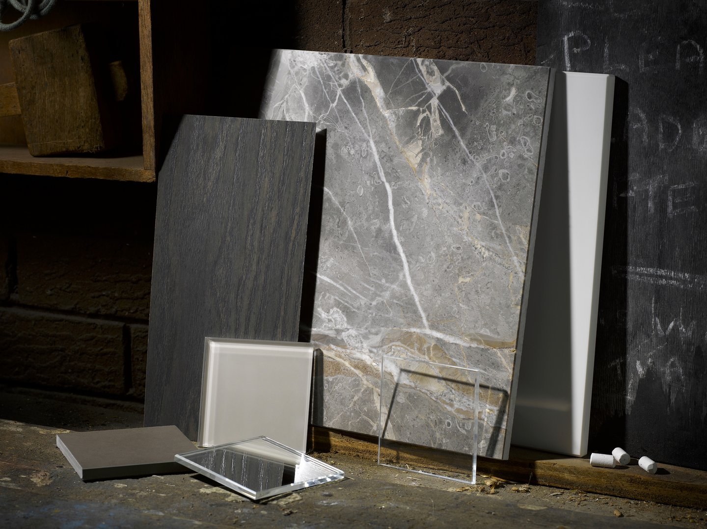 pieces of slate marble and glass leaning against the wall of an old workshop