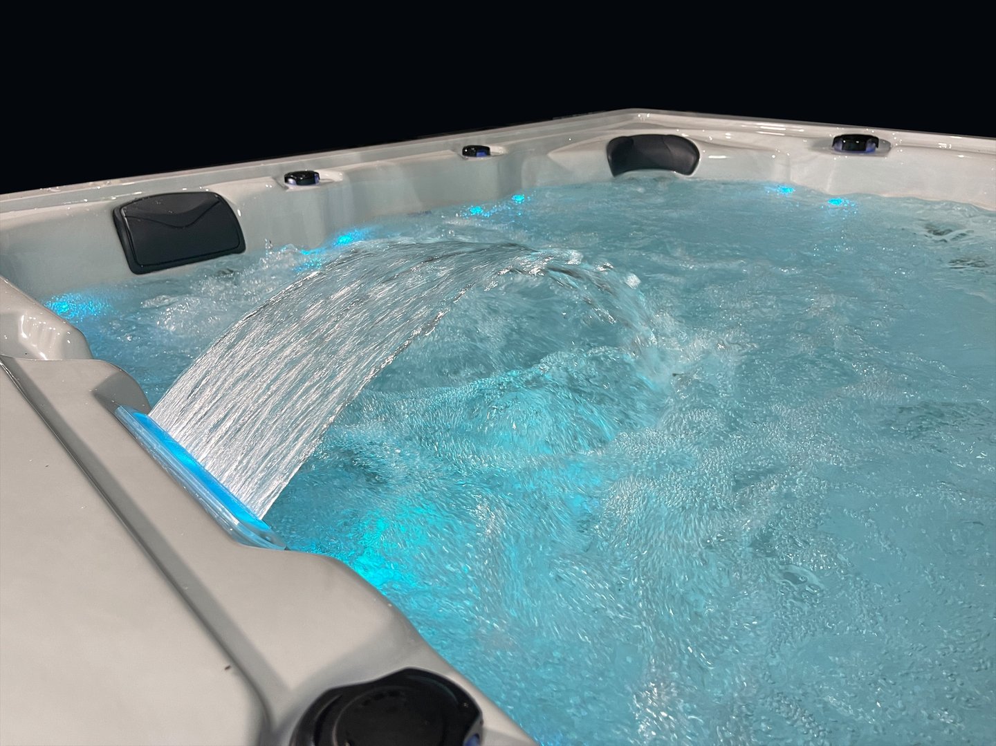 a hot tub with a waterfall flowing down the side