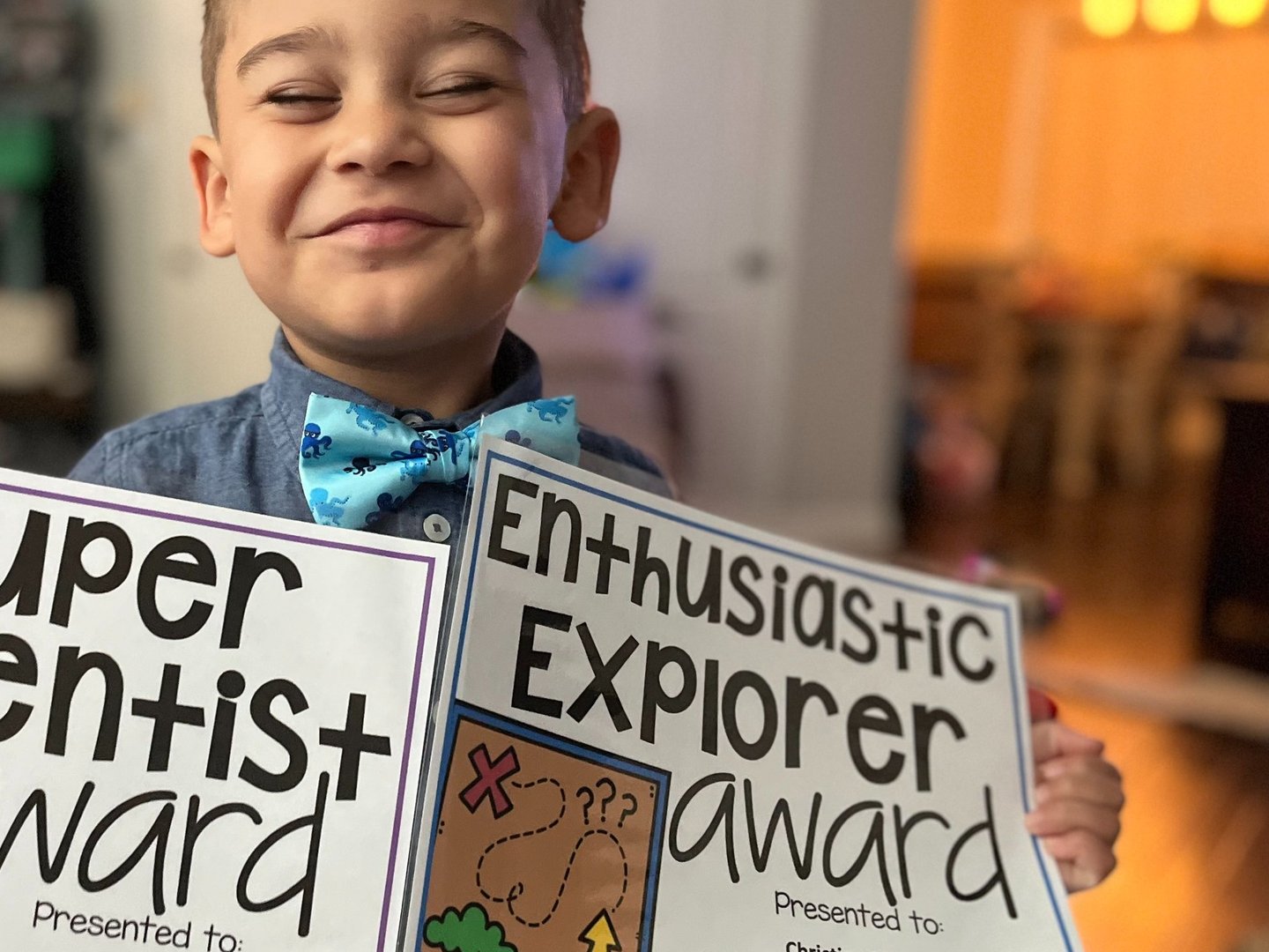 boy holding certificates
