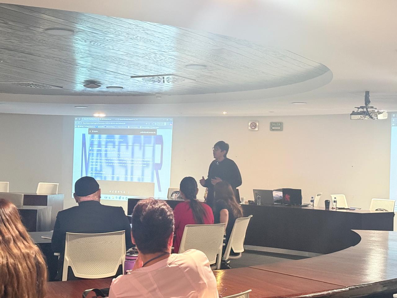 Professional speaker presenting a digital marketing workshop to an audience in a modern conference room.