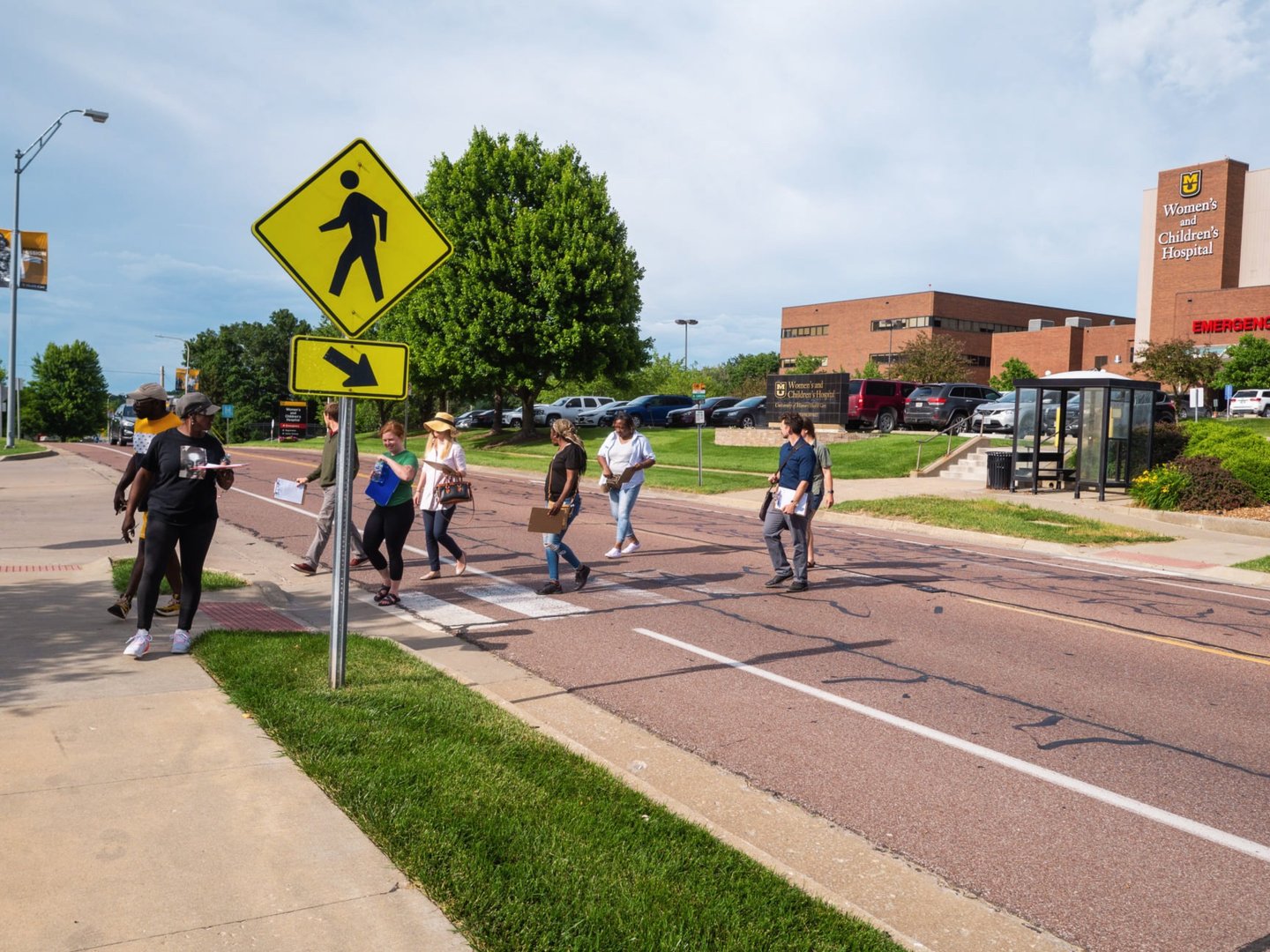 Group of people walking across a crosswalk