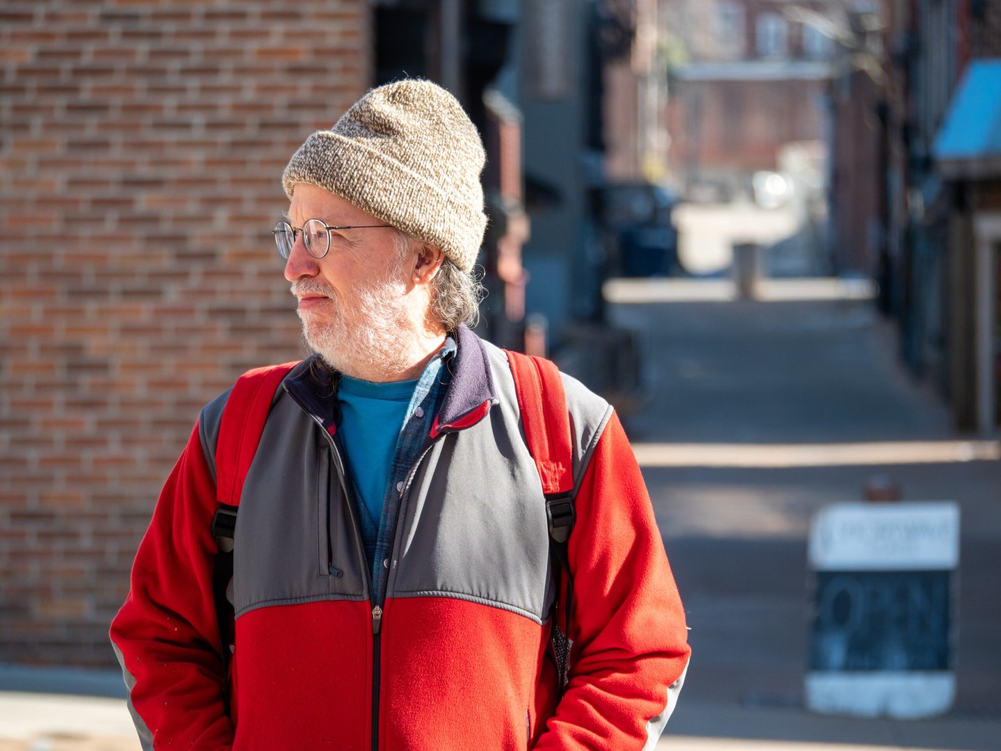 Headshot of Jack Gardiner in a city looking to the side