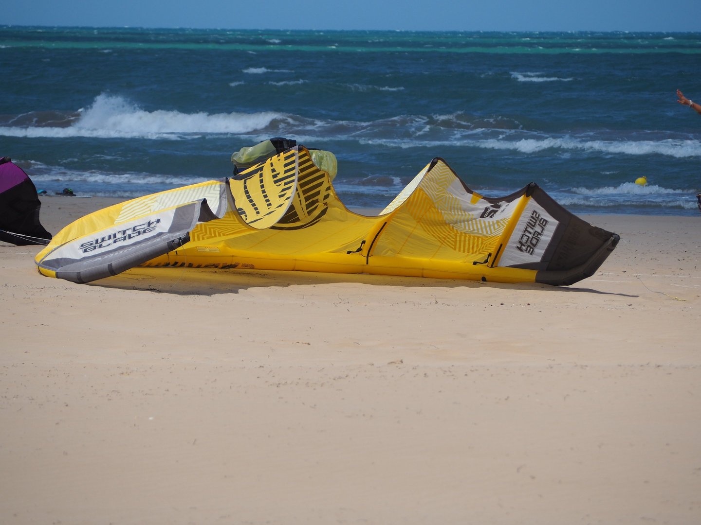 una vela da kitesurf adagiata sulla spiaggia