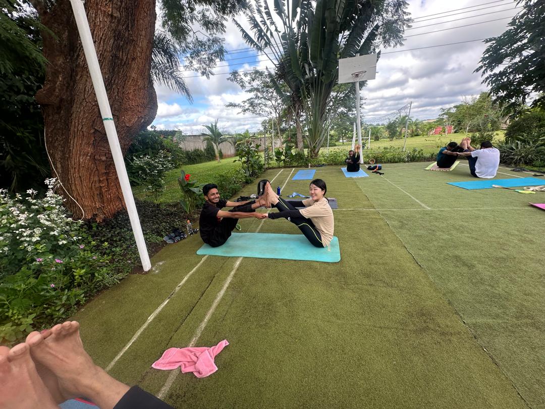 yoga participants trying partner pose for flexibility and endurance