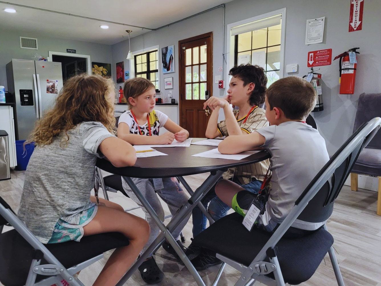 a group of children sitting around a table brainstorming ideas