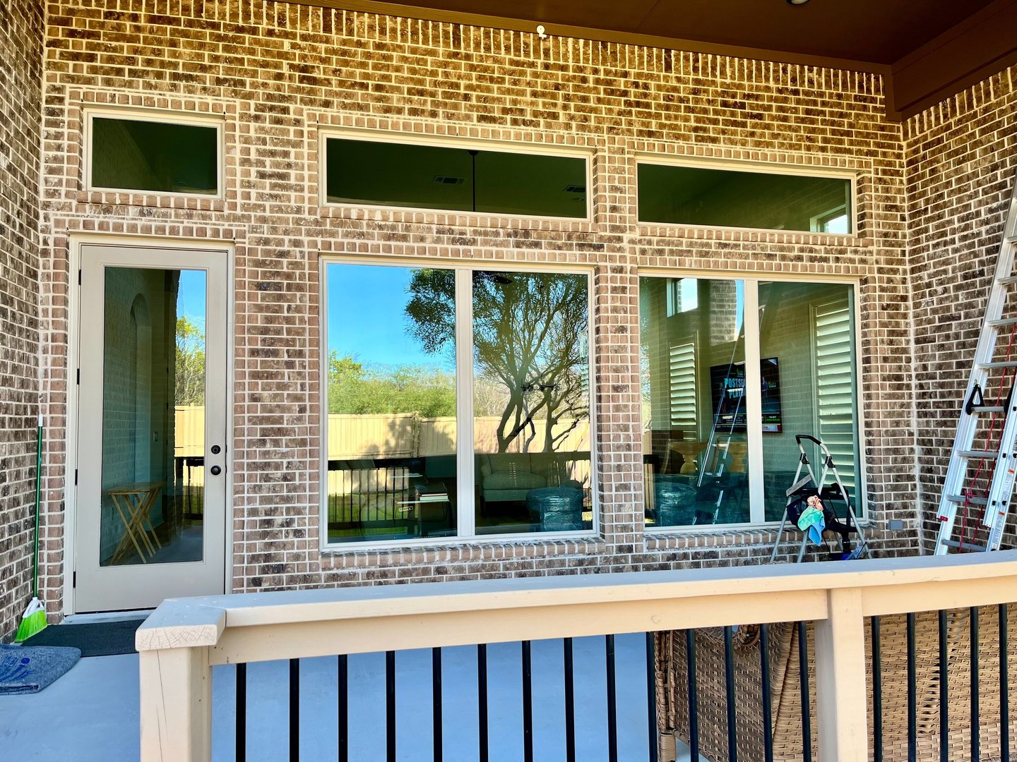 Clean reflective windows on a brick home exterior, Elegant Restorations San Antonio