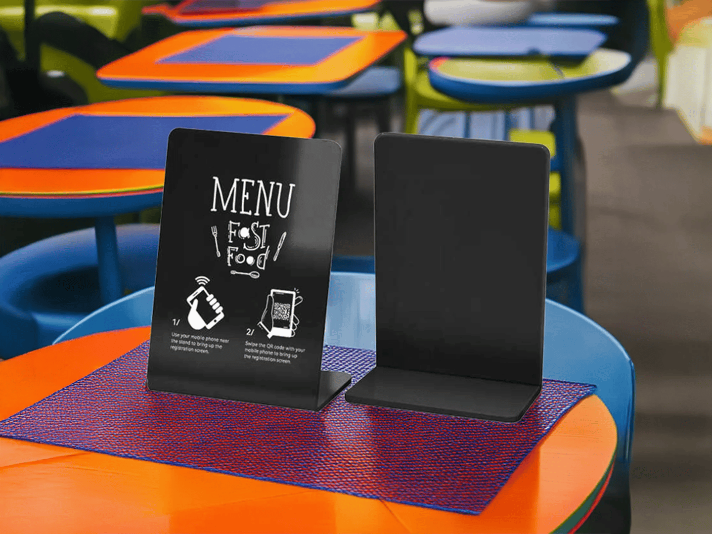 Small NFC display stand on table of a fast food restaurant, showing menu and promo content.