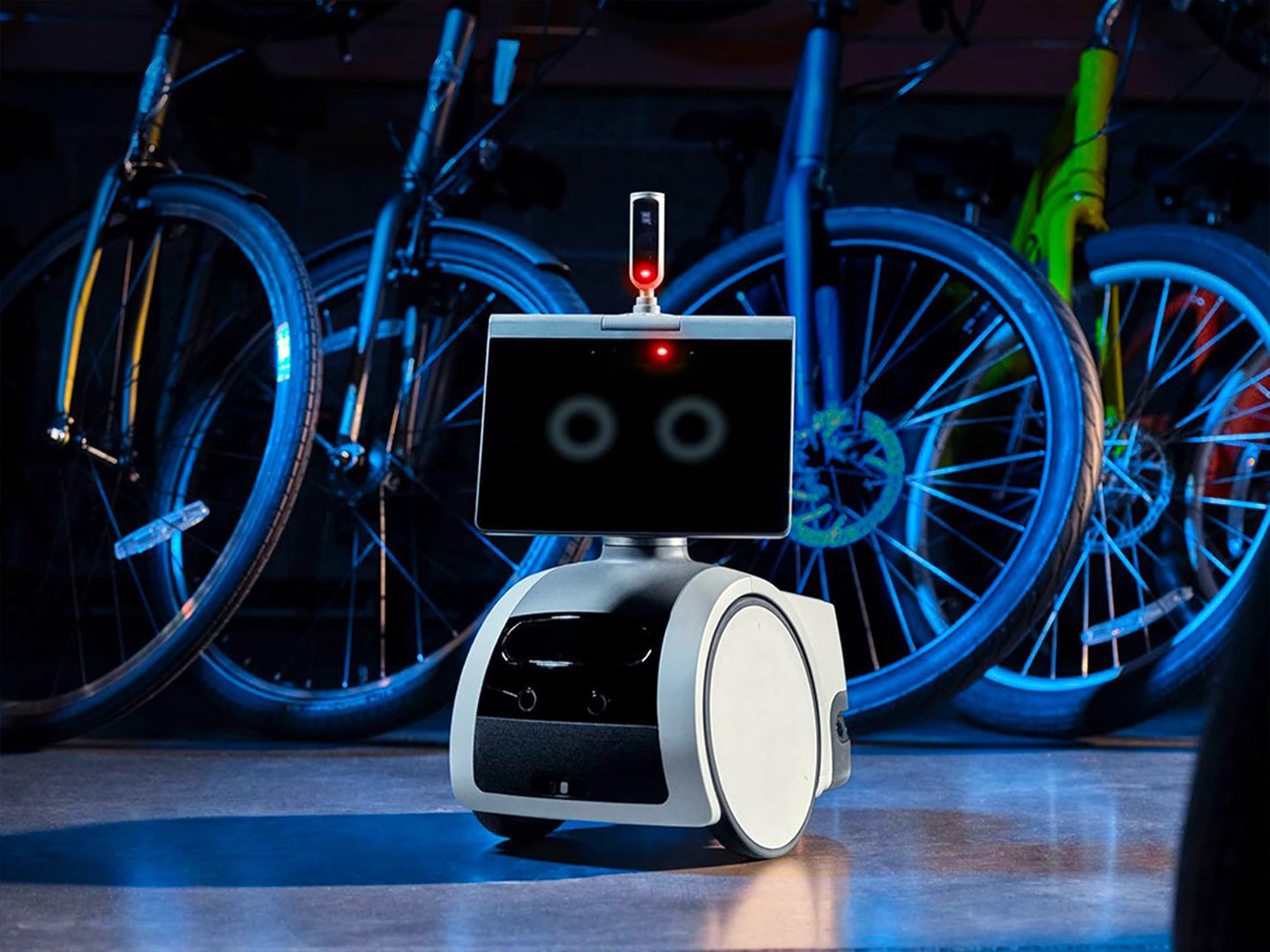 Surveillance robot with tablet face in bike shop. Business tech and security protection solution.