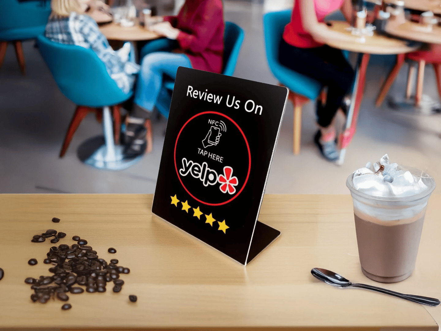 Yelp NFC review sign on cafe counter with coffee and beans. Boost feedback using digital tech.