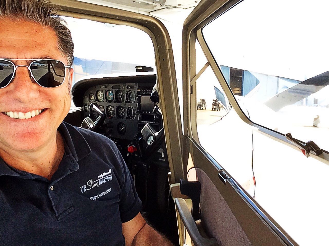 A photo of Marc Lee in front of the cockpit of his Cessna 172