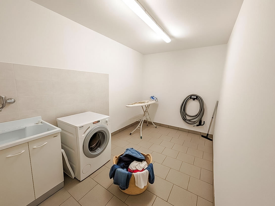 a laundry room with a washing machine and a laundry basket