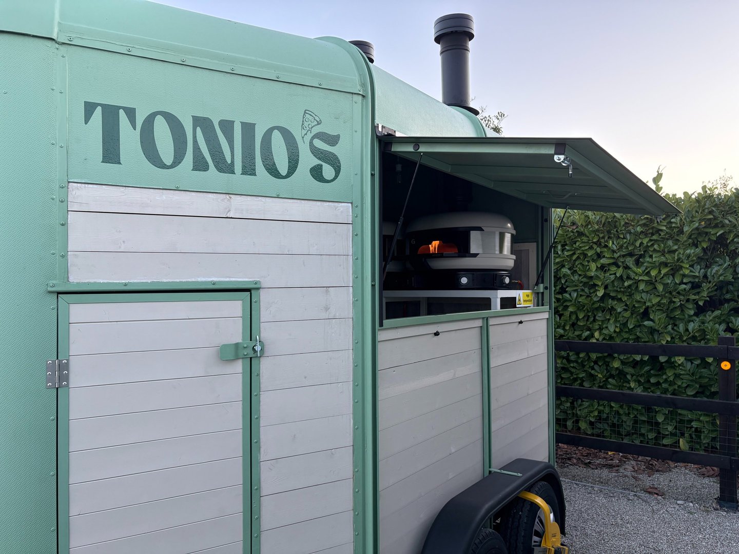 Tonio's green mobile pizzeria trailer